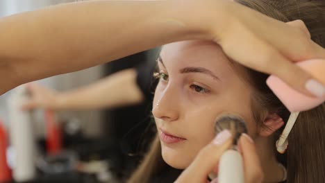 captivating view of makeup being expertly applied in a refined professional setting