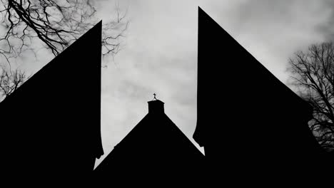 silhouette of a church against a cloudy sky