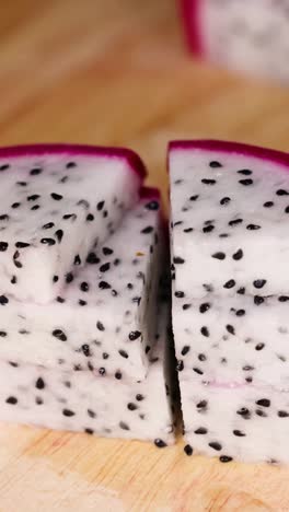 hands slicing dragon fruit into even pieces