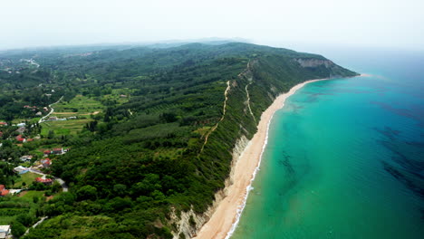 Top-down-Aerial-drone-shot-over-the-long-stretching-empty-sandy-beach-in-Corfu-in-Greece