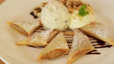 fork cutting into pastries with ice cream topping