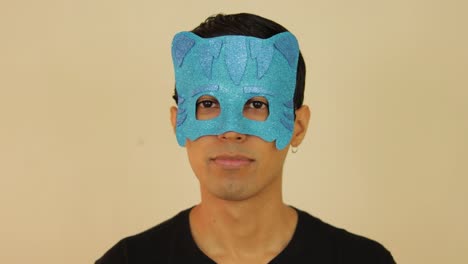 latin young male disguised as pj cartoon with a children's mask