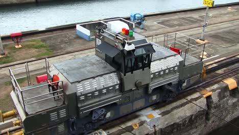 top view of a electric locomotive pulling the ship at panama canal