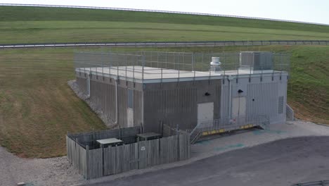 Low-close-up-aerial-shot-of-the-maintenance-utility-building-at-the-Wakarusa-River-spillway-in-Kansas