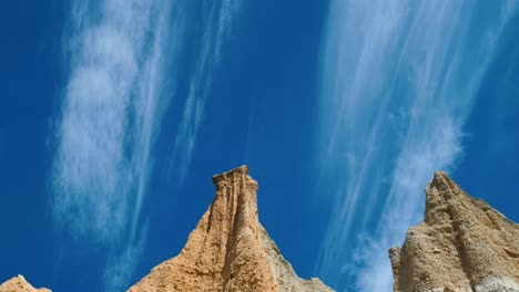 clay cliff's serenity: clouds drift above captivating clay formations in mesmerizing stock footage