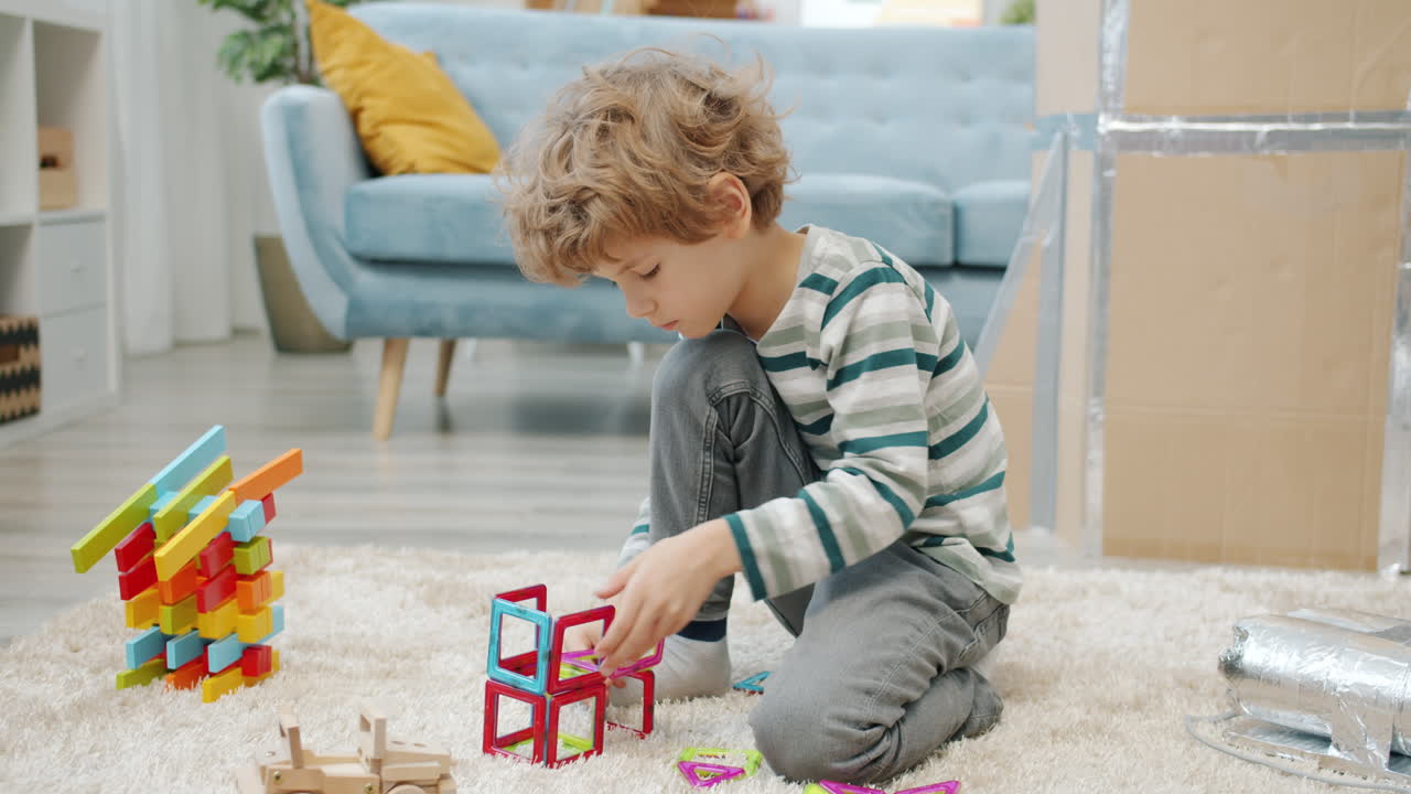 Child Playing with Magnetic Tiles and Wooden Blocks