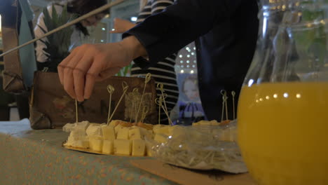 hombre tomando queso de la mesa del buffet
