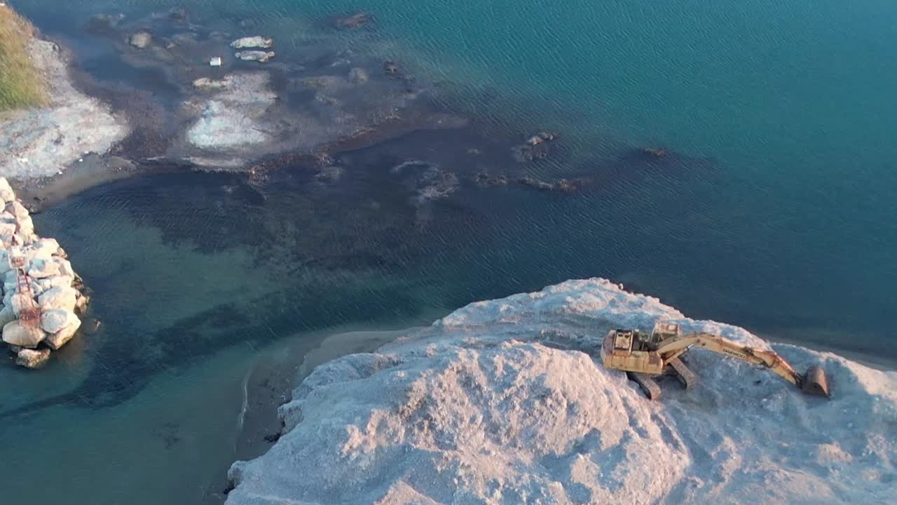 Aerial view of rocky shoreline and sandy area in Greece