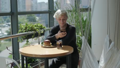 guy eating burger in restaurant