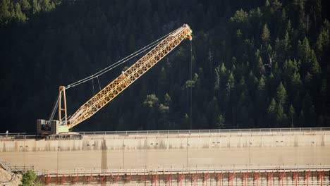 a construction crane working on the dam at gross reservoir in boulder county, colorado, usa