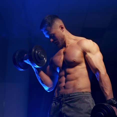 young man holding dumbbell