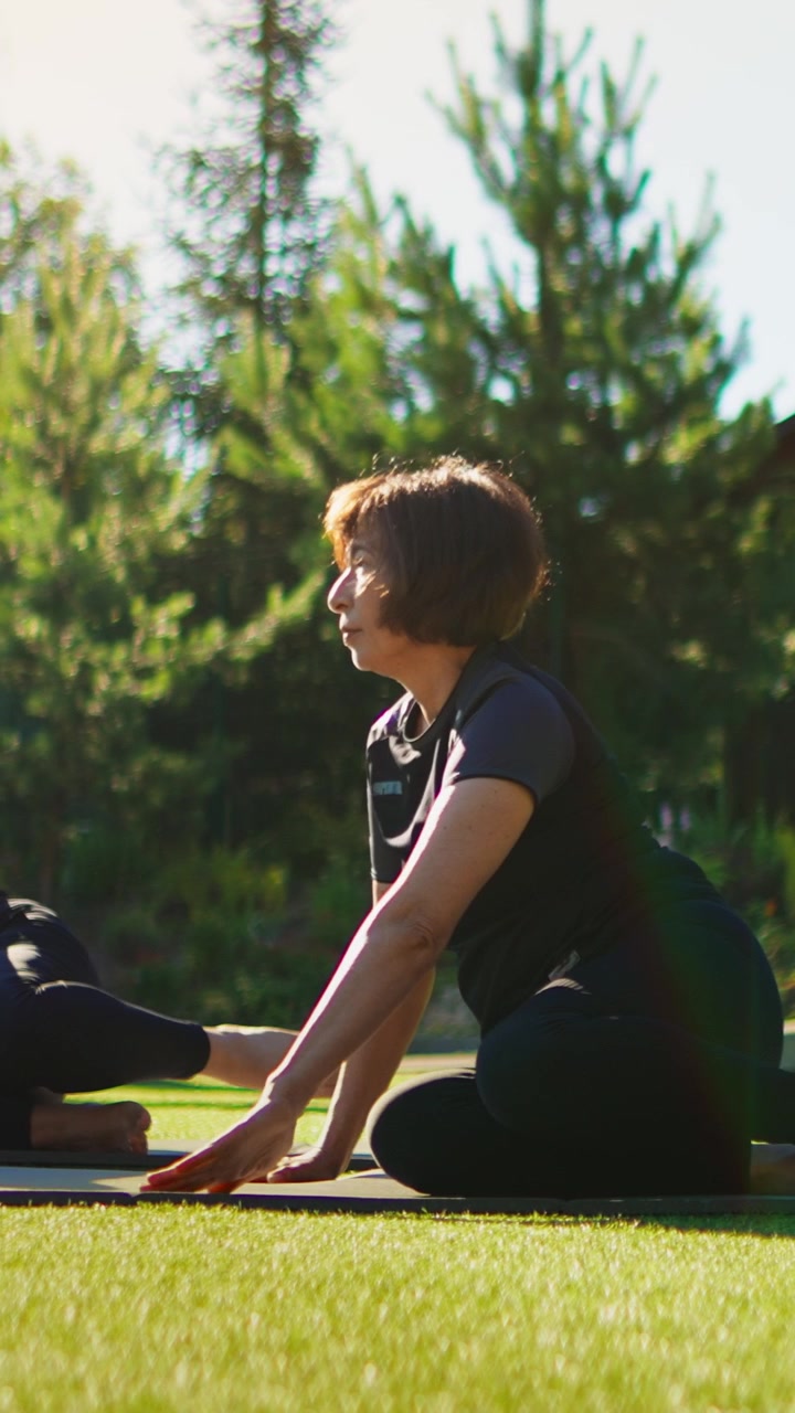 Mature Woman Practicing Yoga Outdoors in a Park