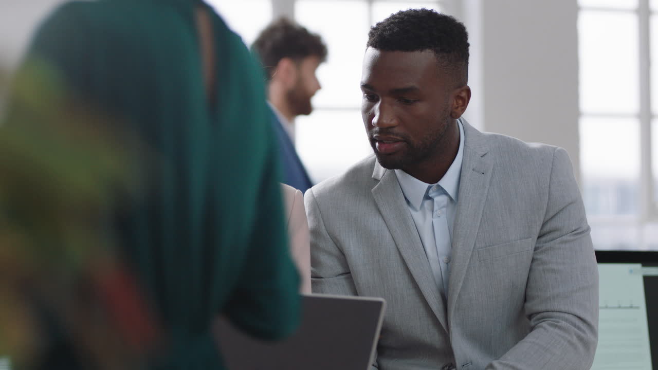 business meeting team leader woman brainstorming with businessman colleague using laptop computer showing ideas pointing at screen working together in office