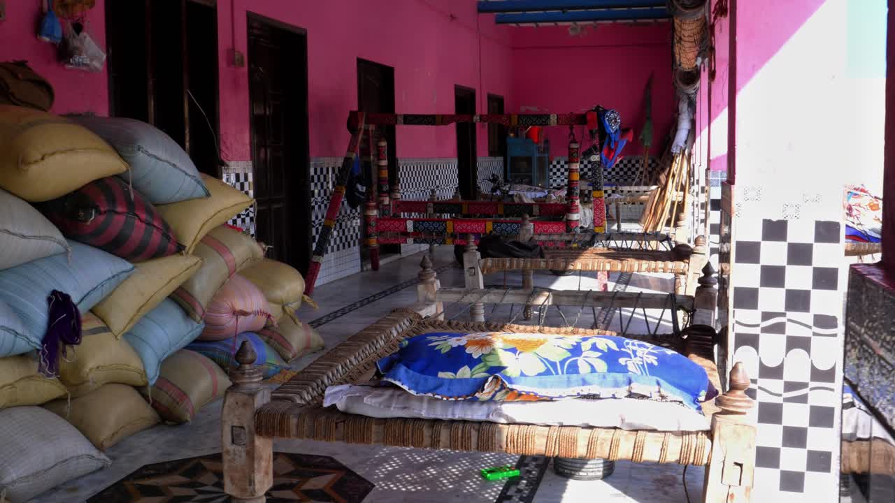 Revealing shot multiple charpais at a rural household in a village in Sukkur of Sindh, Pakistan