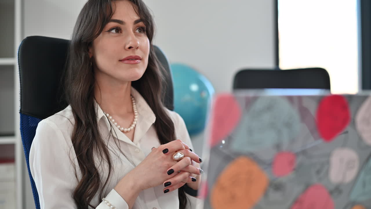 Woman talking at a desk in an office