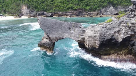 natural stone arch bridge and rock formation of limestone sea mount formed by waves and coastal erosion