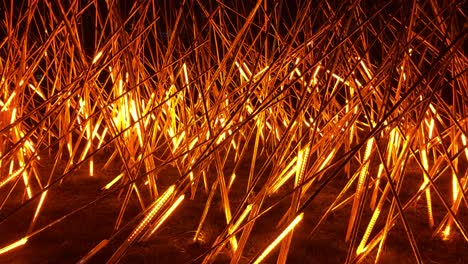 impressive artwork made of light installation simulating burning fire at an art event and outdoor exhibition