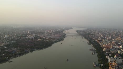 aerial drone capture of howrah bridge and hooghly river, showcasing the vibrant activity around the area.