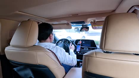 driver navigating with gps inside a car