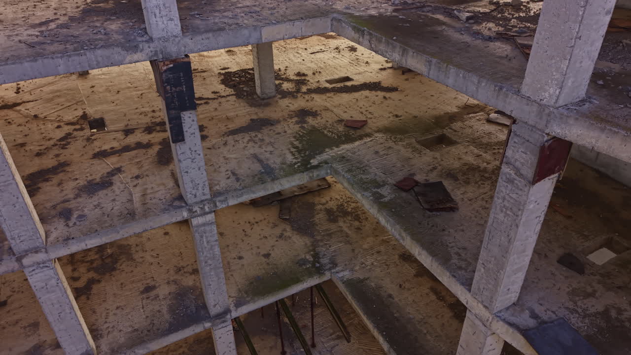 Abandoned construction site reveals mysterious deep well surrounded by crumbling concrete in midday light