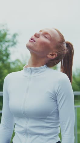 focused athlete stretching: a determined woman in athletic gear prepares for a workout while overcoming challenges in a serene outdoor setting