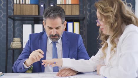 Female-employee-jotting-down-her-manager's-recipes.-Office-work.