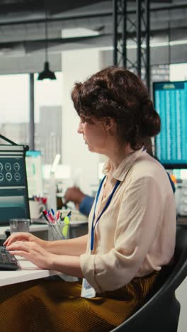 vertical video female advisor in workstation thinking about a new strategy to increase profit
