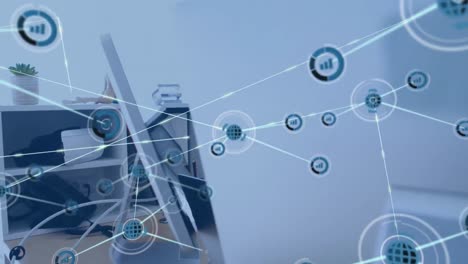 animación de una red de iconos digitales contra un hombre caucásico que usa una computadora en la oficina
