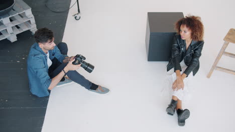 photographer taking photos of a model in a studio