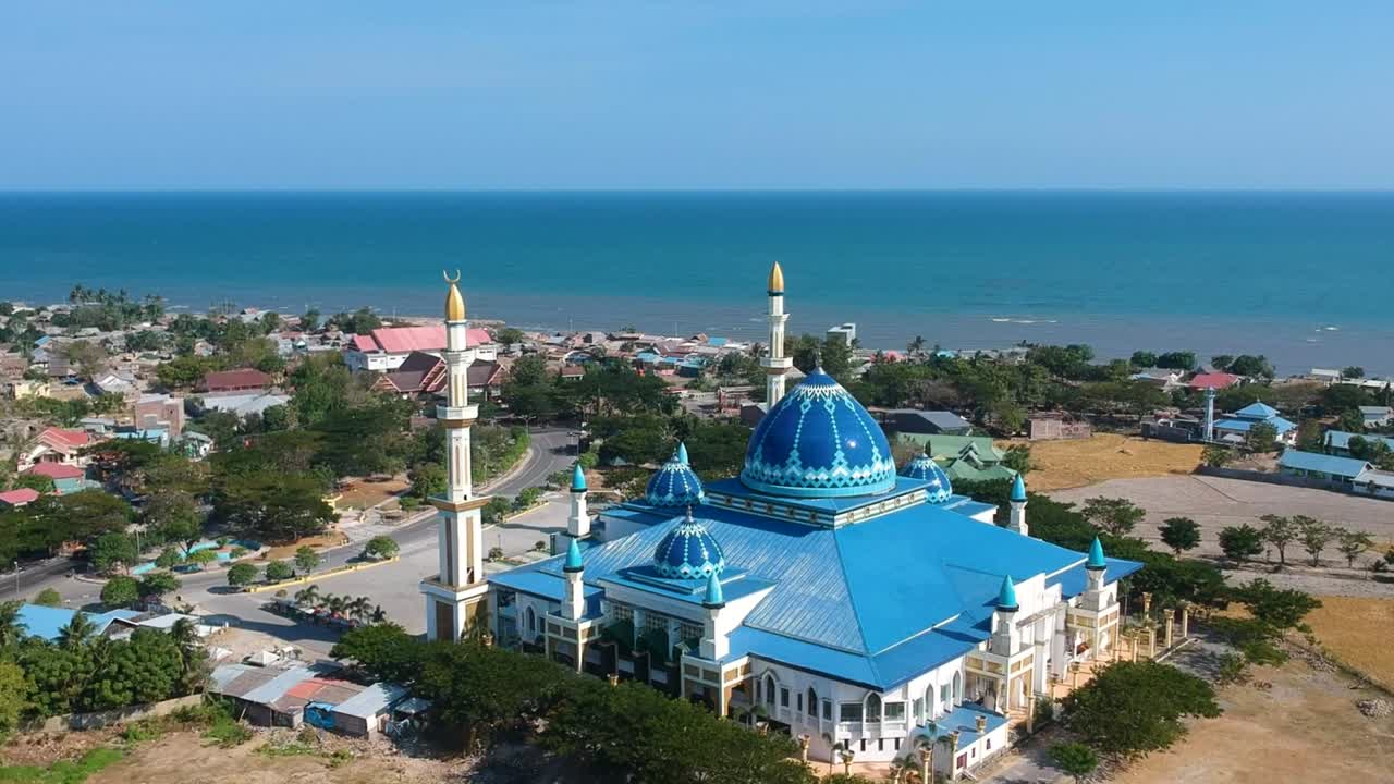 Aerial of the Islamic Center Dato Tiro Bulukumba mosque and school for Islamic education with sea in South Sulawesi, Indonesia