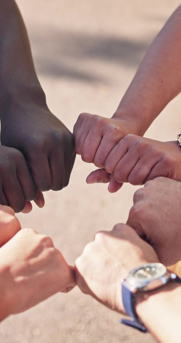 Diverse Group of People Joining Hands in a Circle