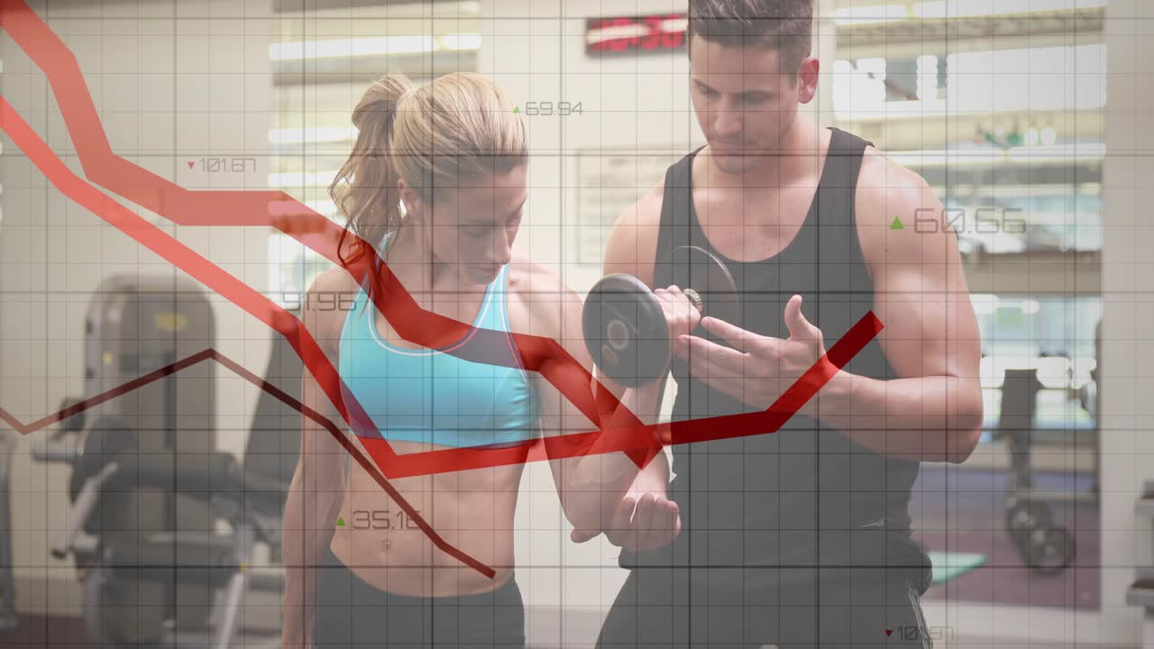 Woman holding dumbbell starting grid red lines as trainer guiding wrist, fixing form in gym