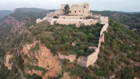 drone vertical shot of miravet castle at top of hill tarragona, spain