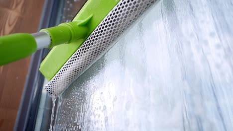 cleaning windows with squeegee