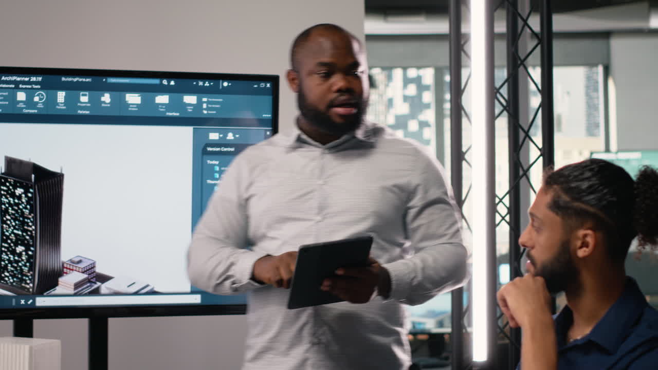 Vertical Video Black contractor reviewing architectural software and 3D models with his team