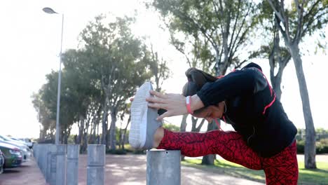 Fit-woman-doing-stretching-exercise-on-bollard-4k