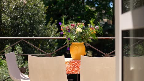 slow establishing shot of flowers sitting ontop of a table at a villa in montpellier