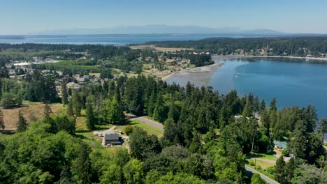 establishing aerial view of freeland, washington with the olympic mountains off in the distance