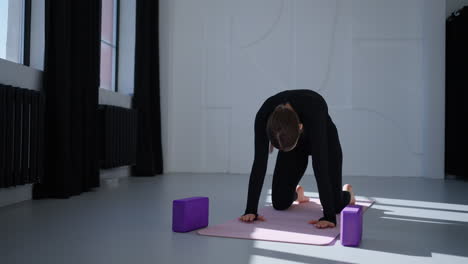 woman practicing yoga in a studio