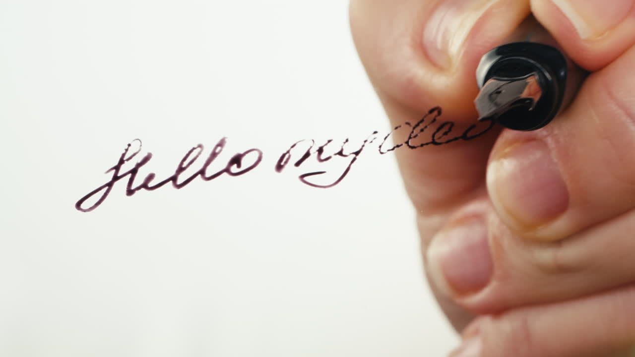 Close-up of Hand Writing 'Hello My Dear' with a Fountain Pen