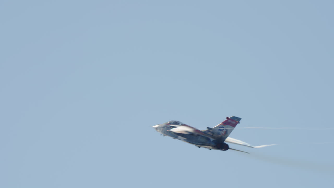 Tornado Fighter Jet Flying with Smoke Trails in Clear Blue Sky