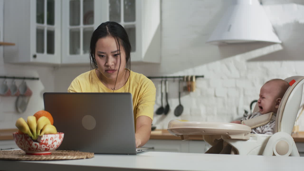 Working Mom with Crying Baby in Kitchen
