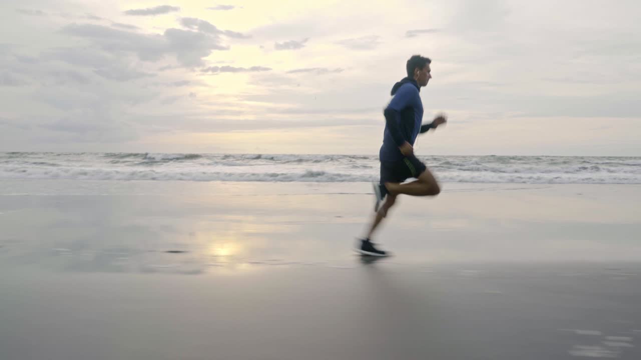 Sporty Man Jogging on Sand