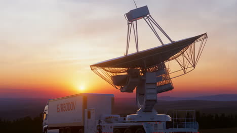 mobile satellite dish on a truck at sunset