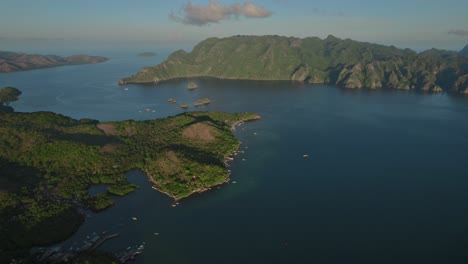 aerial - philippines coastline, green hills meeting the vast ocean