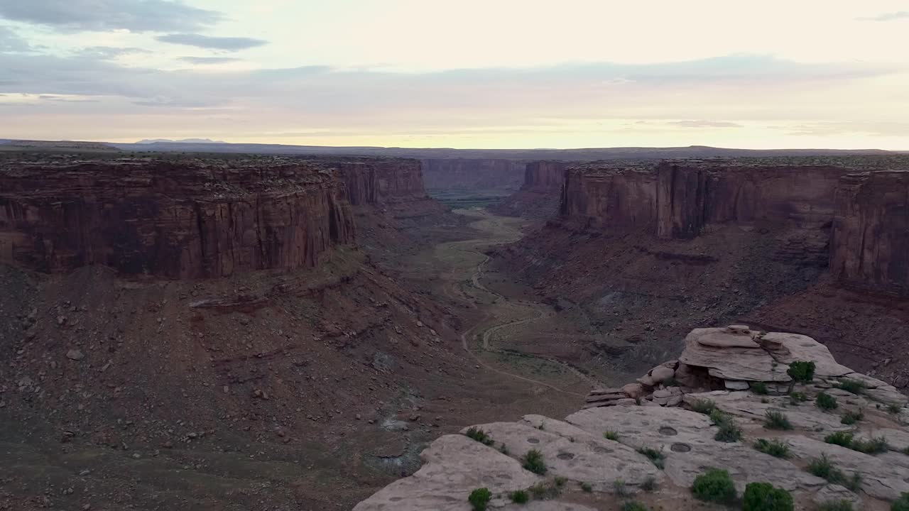 A 4K, sunset drone shot over the "Fruit Bowl", and the steep cliffs of Mineral Canyon, a famous highlining area found deep in the heart of Moab’s share of the Colorado Plateau, in Utah