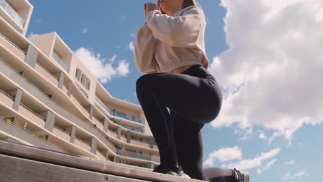 a woman doing a leg squat exercise during summertime