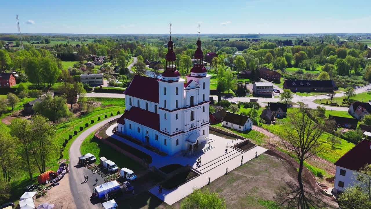 Majestic church in Lithuania with scenic countryside, drone aerial view showcasing rural beauty