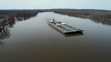 a towboat pushes fuel barges north on the mississippi river