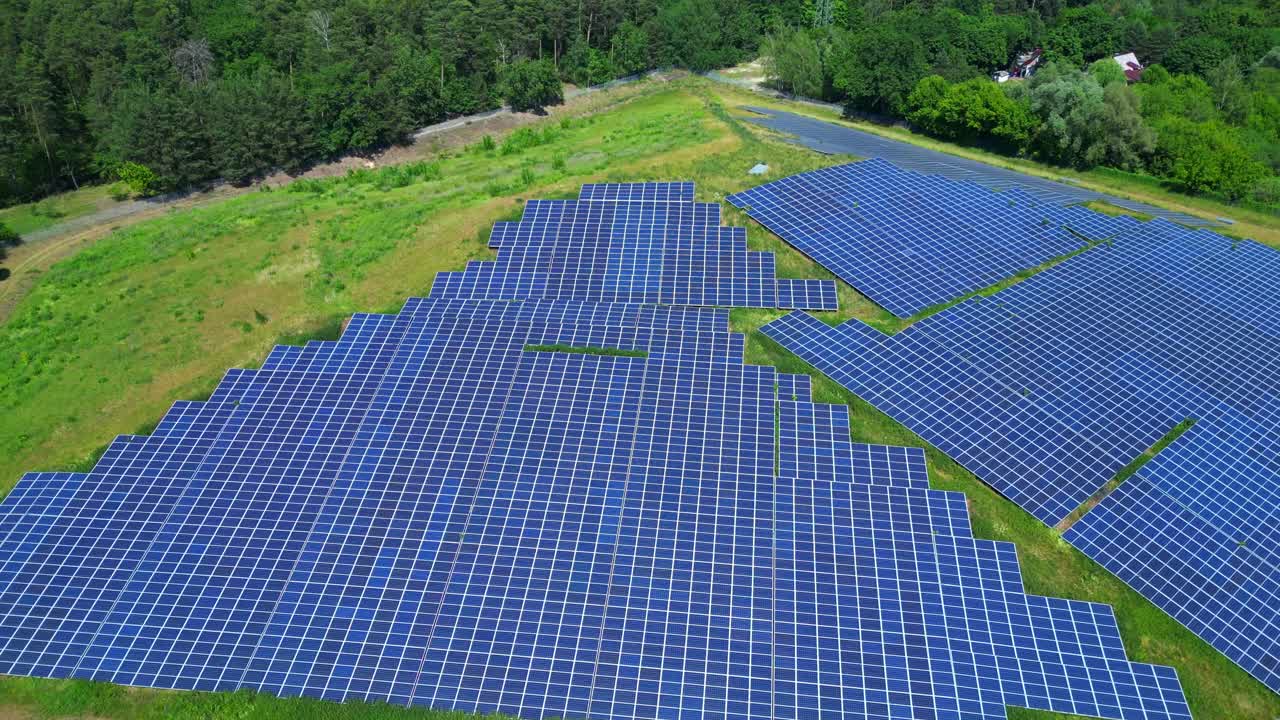 Photovoltaic panels installed on a former landfill, transforming a waste site into a source of renewable energy, a solution for the future. Unique aerial view flight ascending drone